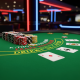 A premium online blackjack game interface showing a player's hand and a dealer's up-card on an emerald green virtual felt table, with virtual chips in the betting area, set against a blurred modern digital casino lobby background.